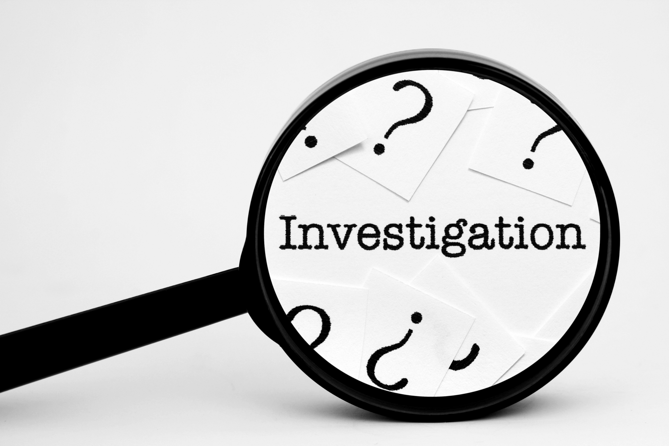 magnifying glass on word "investigation"; private detective Hamburg Germany, private investigator Hamburg Germany, detective agency Hamburg Germany